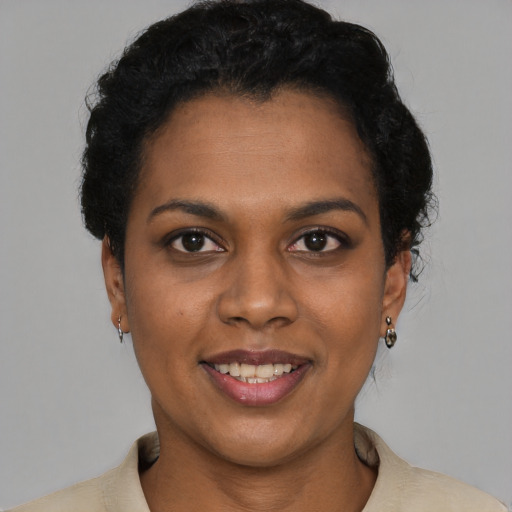 Joyful latino young-adult female with short  black hair and brown eyes