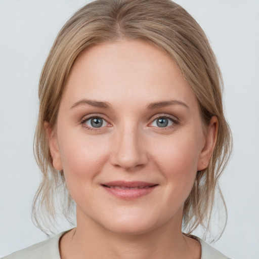 Joyful white young-adult female with medium  brown hair and blue eyes