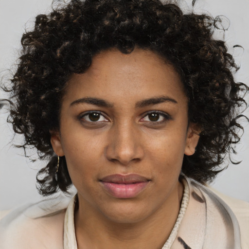 Joyful black young-adult female with medium  brown hair and brown eyes