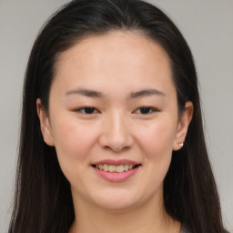 Joyful asian young-adult female with long  brown hair and brown eyes