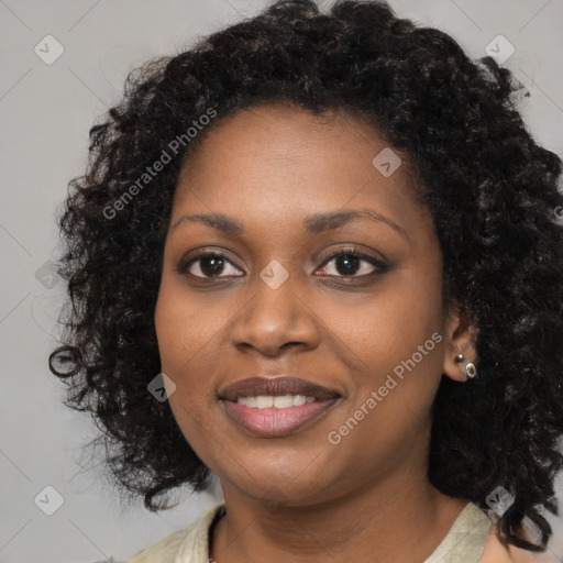 Joyful black young-adult female with long  black hair and brown eyes