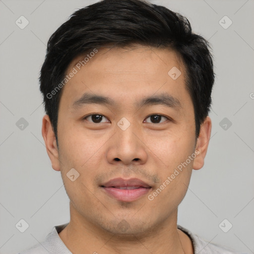 Joyful asian young-adult male with short  black hair and brown eyes