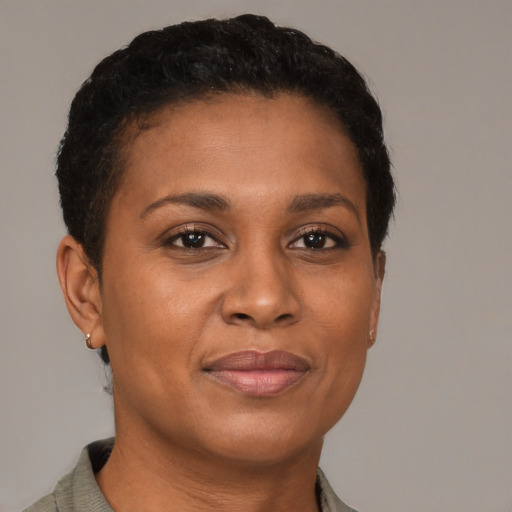Joyful black young-adult female with short  brown hair and brown eyes