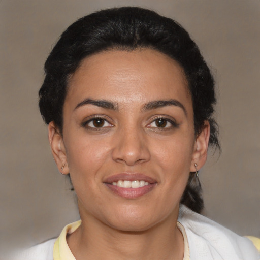 Joyful latino young-adult female with short  black hair and brown eyes