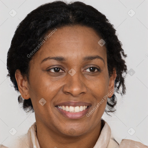 Joyful black adult female with short  brown hair and brown eyes