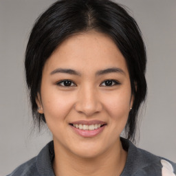 Joyful asian young-adult female with medium  black hair and brown eyes