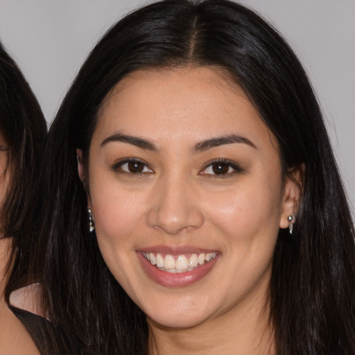 Joyful white young-adult female with long  brown hair and brown eyes