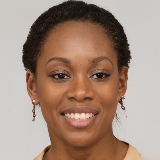 Joyful black young-adult female with short  brown hair and brown eyes
