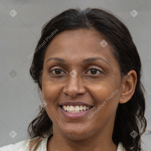 Joyful latino adult female with medium  brown hair and brown eyes