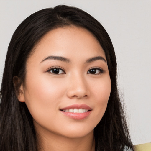 Joyful white young-adult female with long  black hair and brown eyes