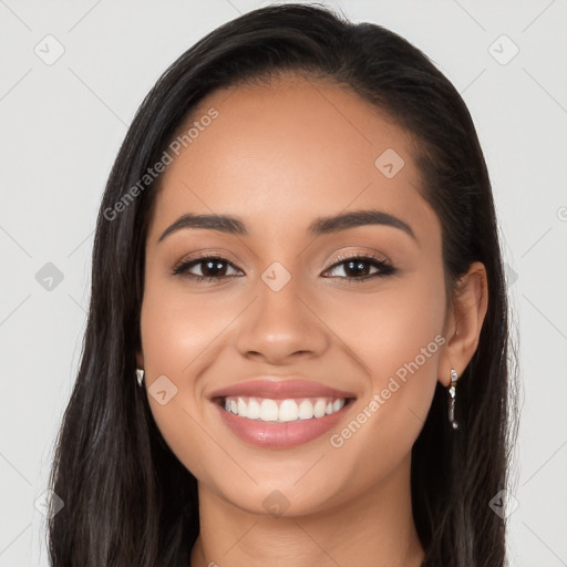 Joyful latino young-adult female with long  brown hair and brown eyes