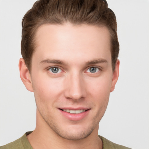 Joyful white young-adult male with short  brown hair and grey eyes