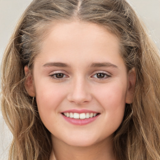 Joyful white child female with long  brown hair and brown eyes