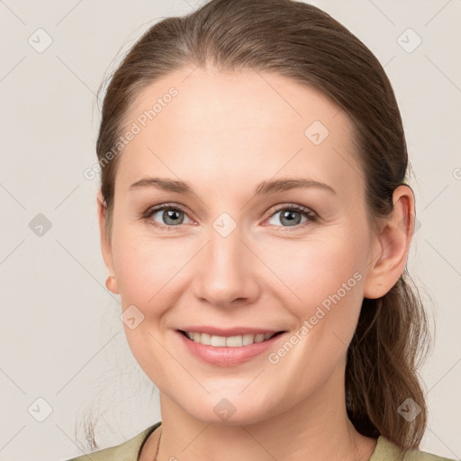 Joyful white young-adult female with medium  brown hair and grey eyes