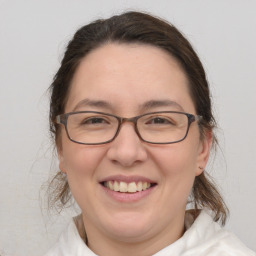 Joyful white adult female with medium  brown hair and brown eyes