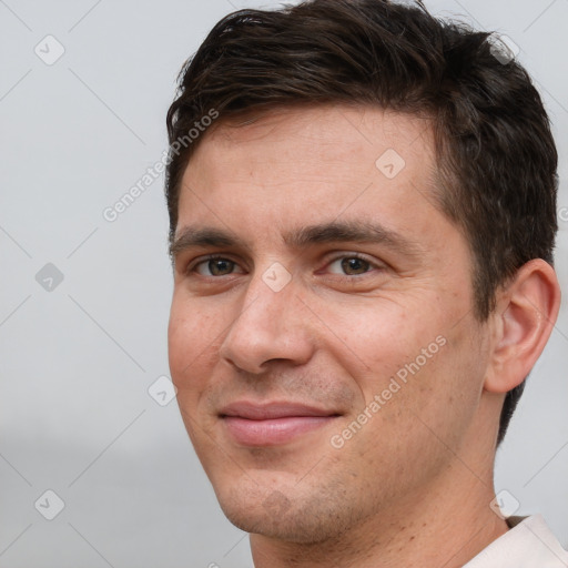 Joyful white adult male with short  brown hair and brown eyes