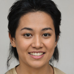 Joyful asian young-adult female with medium  brown hair and brown eyes