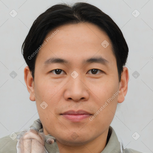 Joyful asian young-adult male with short  brown hair and brown eyes