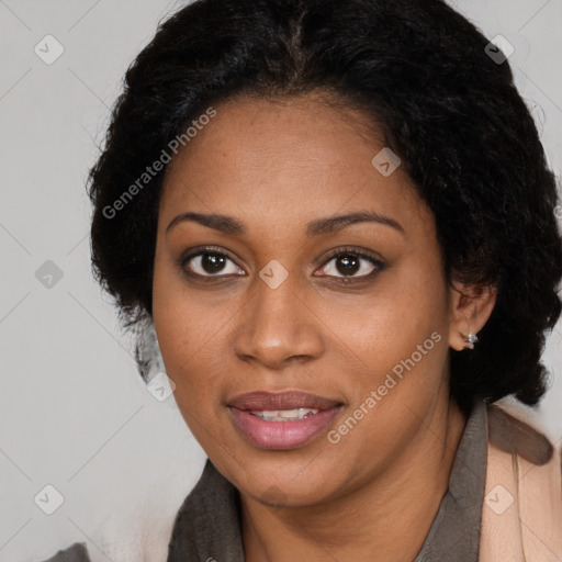 Joyful black young-adult female with long  black hair and brown eyes