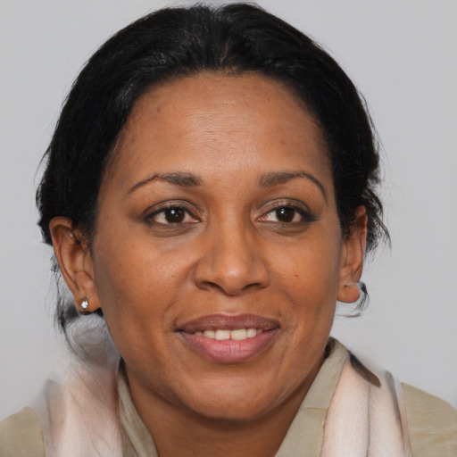 Joyful black adult female with medium  brown hair and brown eyes