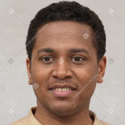 Joyful latino young-adult male with short  brown hair and brown eyes