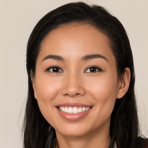 Joyful latino young-adult female with long  black hair and brown eyes