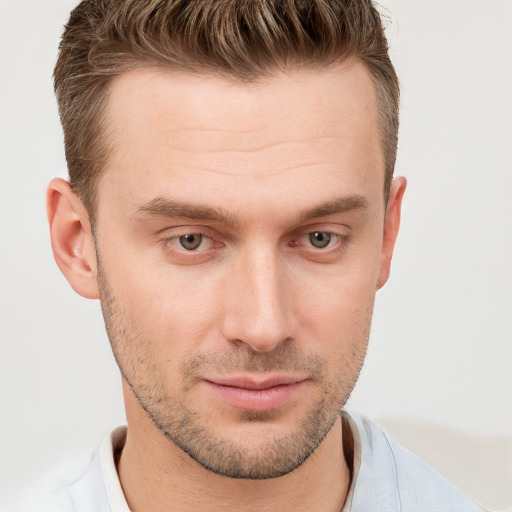 Joyful white young-adult male with short  brown hair and grey eyes