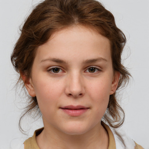 Joyful white child female with medium  brown hair and brown eyes