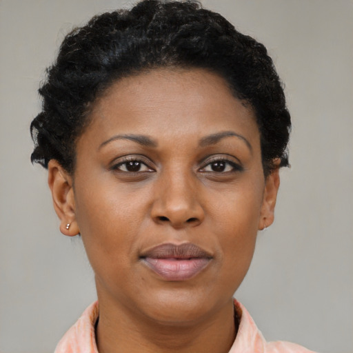 Joyful black adult female with short  brown hair and brown eyes