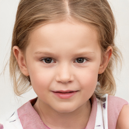 Joyful white child female with medium  brown hair and grey eyes