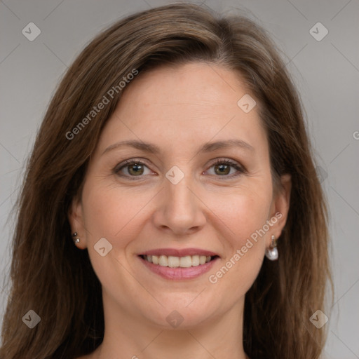 Joyful white adult female with long  brown hair and grey eyes