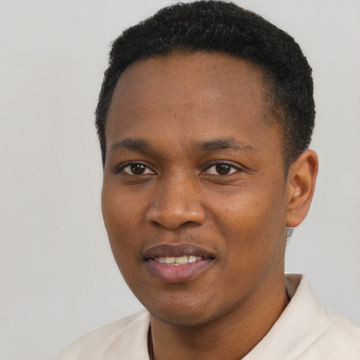 Joyful black young-adult male with short  black hair and brown eyes