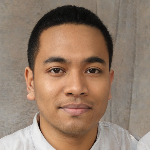 Joyful latino young-adult male with short  black hair and brown eyes