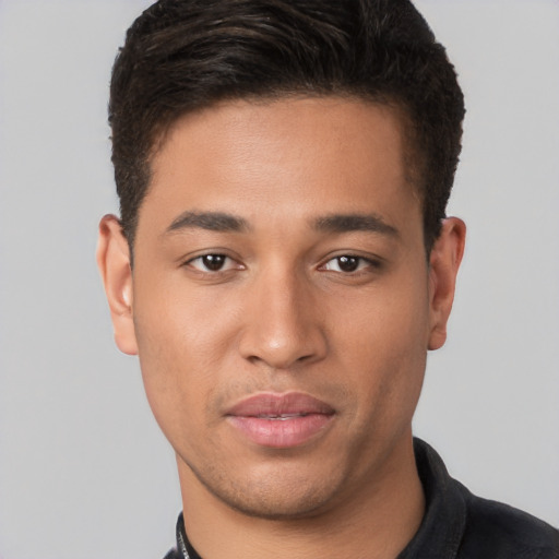 Joyful latino young-adult male with short  brown hair and brown eyes