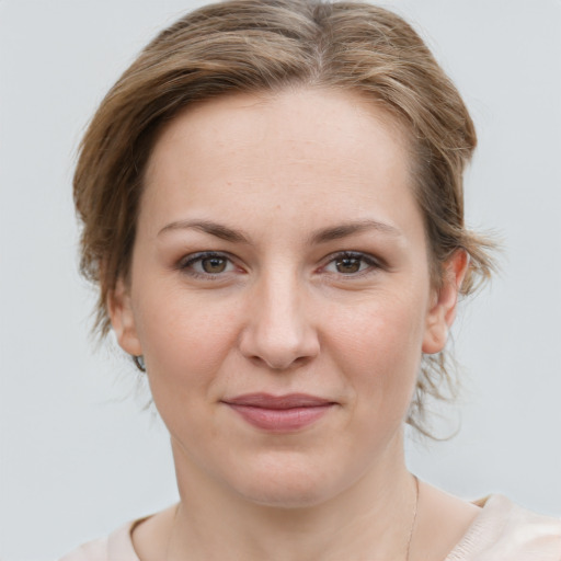 Joyful white young-adult female with medium  brown hair and grey eyes