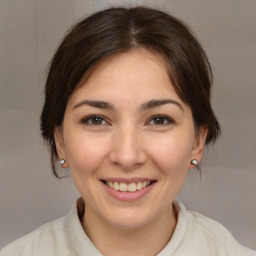 Joyful white young-adult female with medium  brown hair and brown eyes