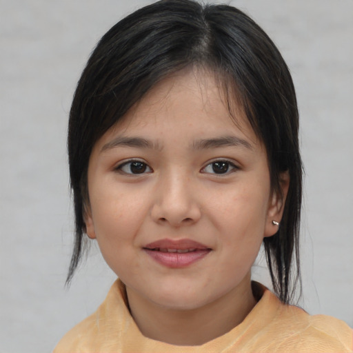 Joyful asian child female with medium  brown hair and brown eyes