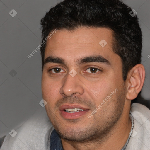 Joyful white young-adult male with short  black hair and brown eyes