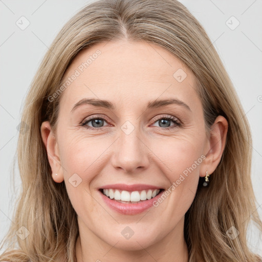 Joyful white young-adult female with long  brown hair and blue eyes