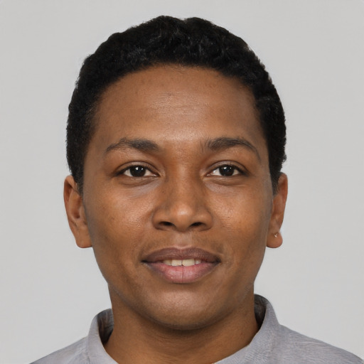 Joyful black young-adult male with short  black hair and brown eyes