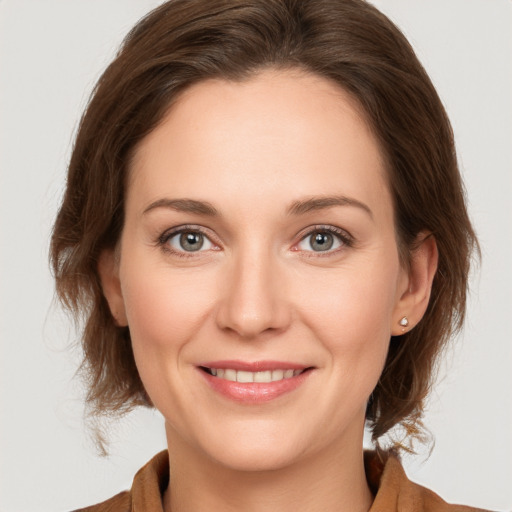 Joyful white young-adult female with medium  brown hair and grey eyes