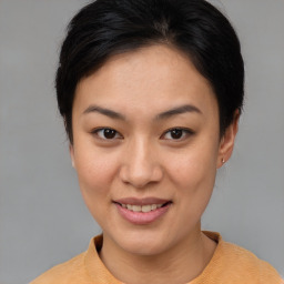 Joyful asian young-adult female with short  brown hair and brown eyes