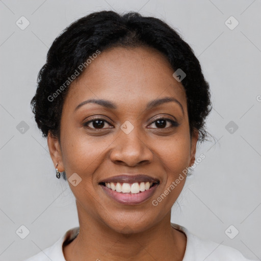 Joyful black young-adult female with short  brown hair and brown eyes