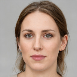 Joyful white young-adult female with medium  brown hair and green eyes