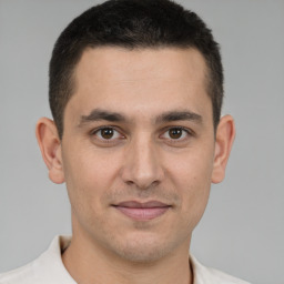 Joyful white young-adult male with short  brown hair and brown eyes