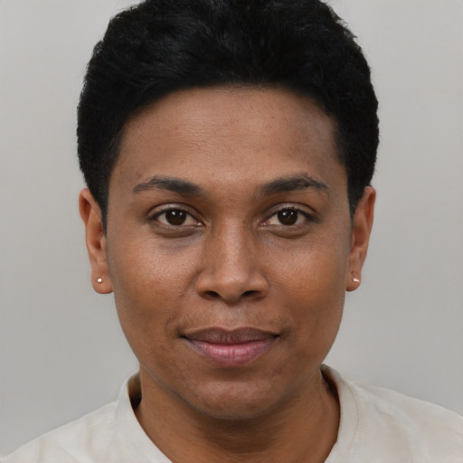Joyful black young-adult female with short  black hair and brown eyes