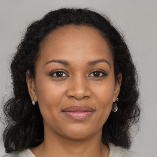 Joyful black young-adult female with medium  brown hair and brown eyes