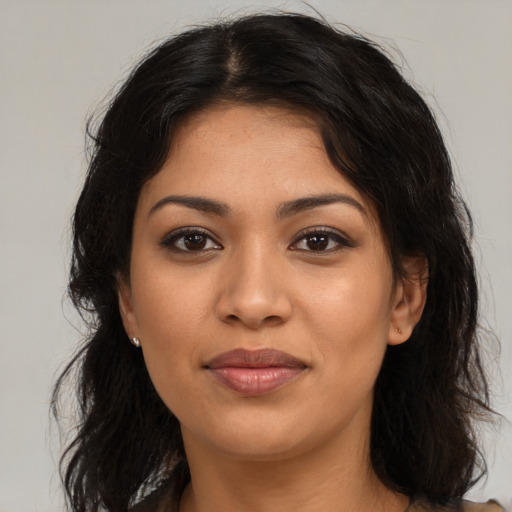 Joyful latino young-adult female with long  brown hair and brown eyes