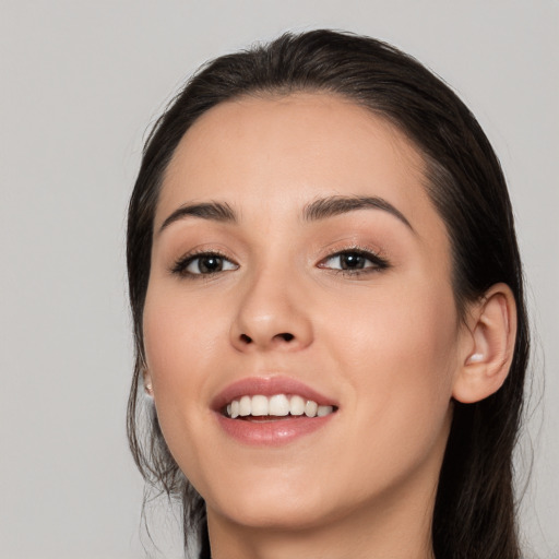 Joyful white young-adult female with long  black hair and brown eyes