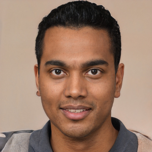 Joyful latino young-adult male with short  black hair and brown eyes
